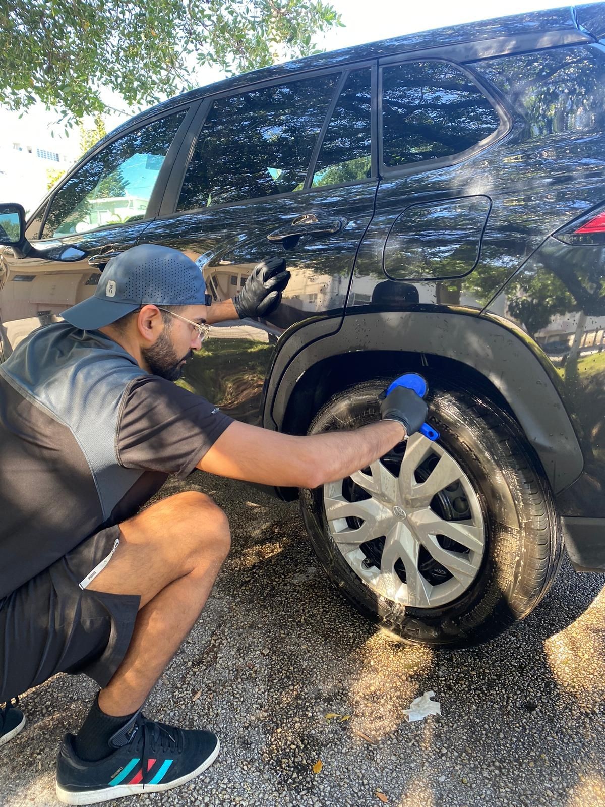 Car service worker sander and polishing. Professional car detailing and maintenance concept