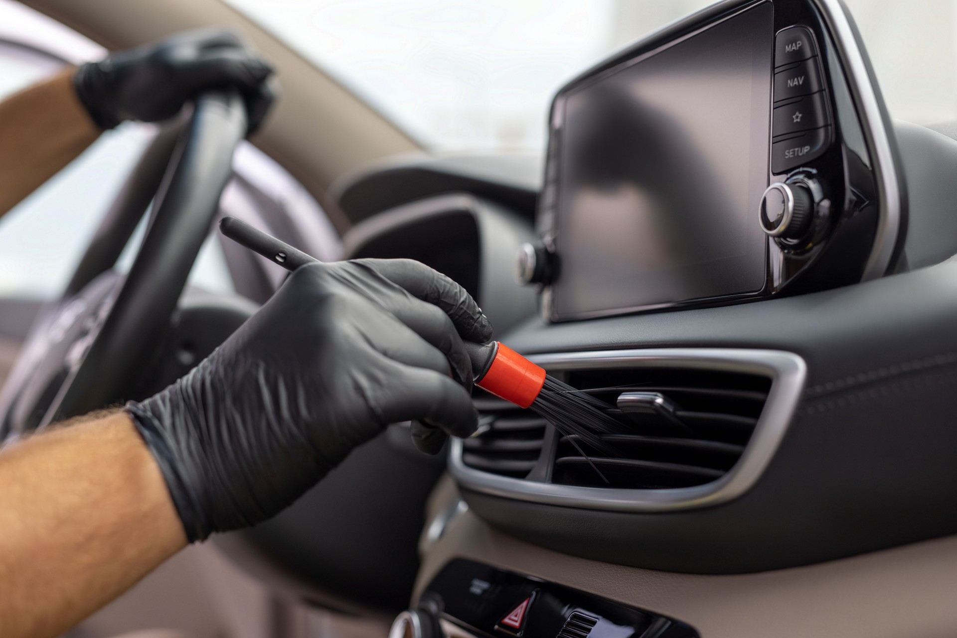 Detailed cleaning car interior elements using special brush